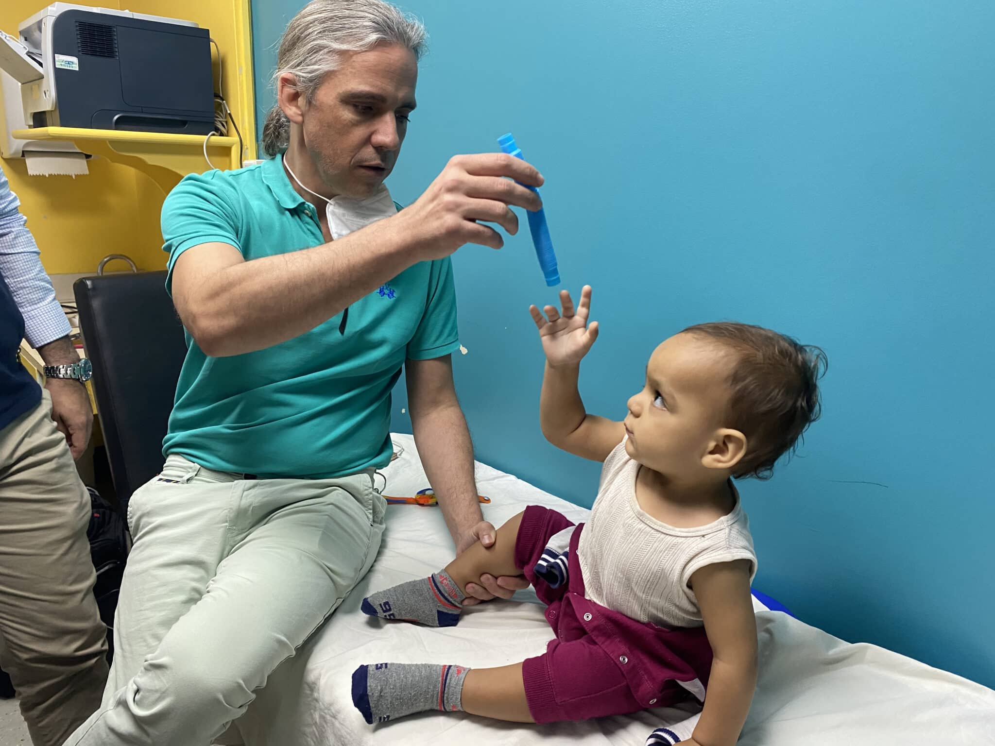 doctor with child preparing for erb's palsy surgery in latin america