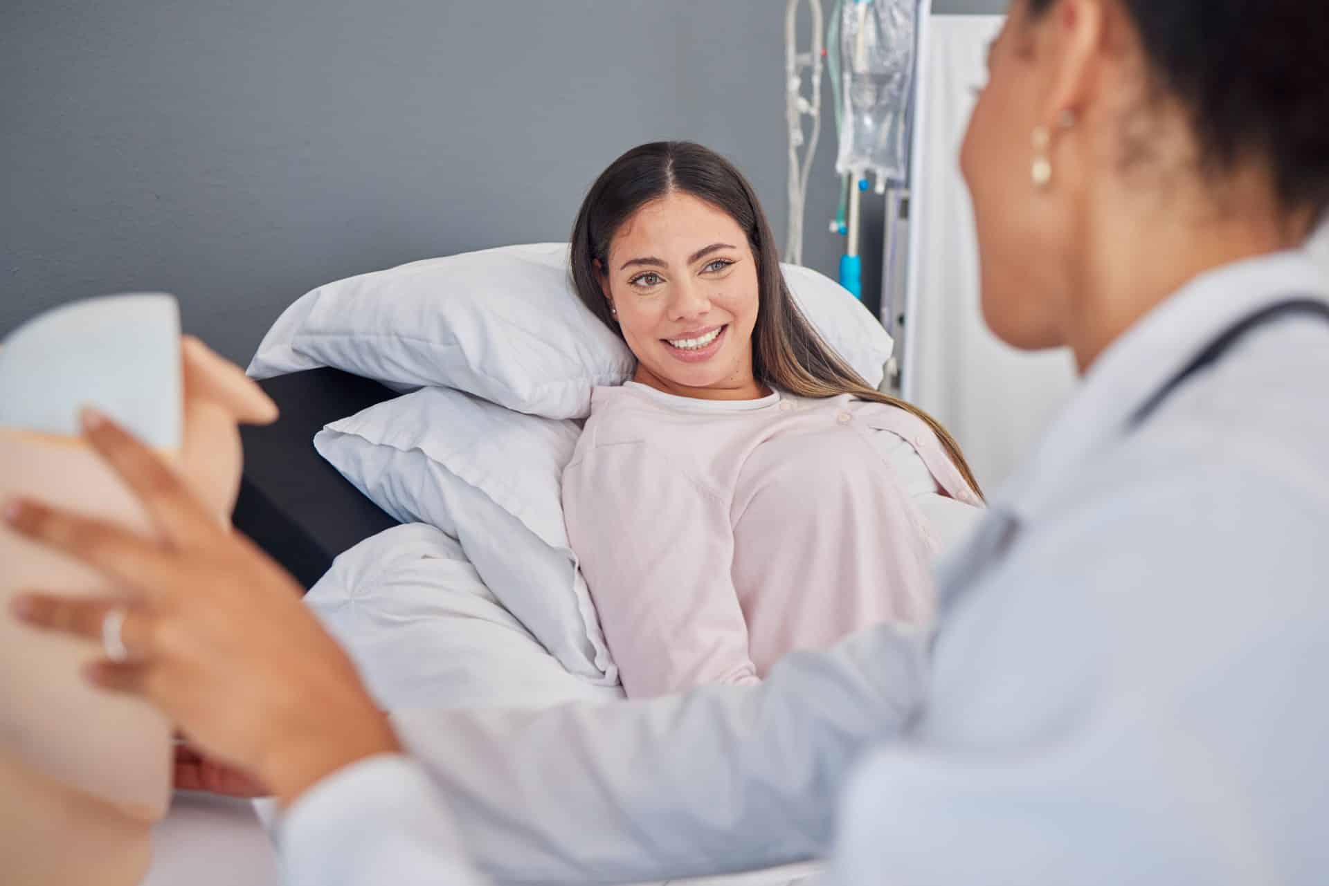 latina woman with caribbean doctor doing a regular checkup and planning for delievry to avoid erbs palsy